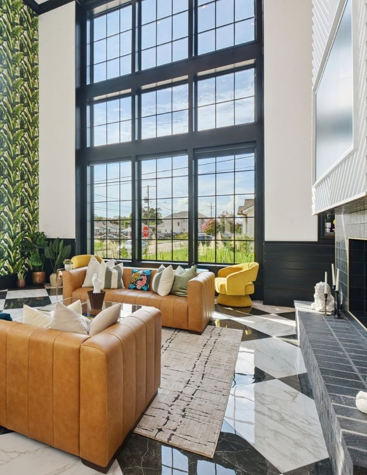 large format checkered tile floors in a grand living room with large windows and tile fireplace