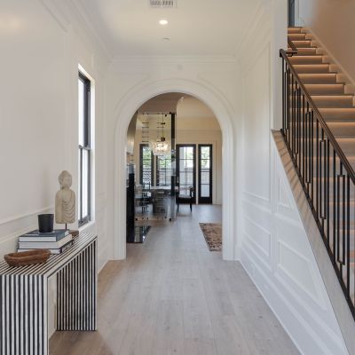 cafe floor design with white counters and blonde wood look floors, accent lighting